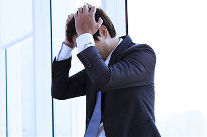 Picture of young businessman suffering panic attack